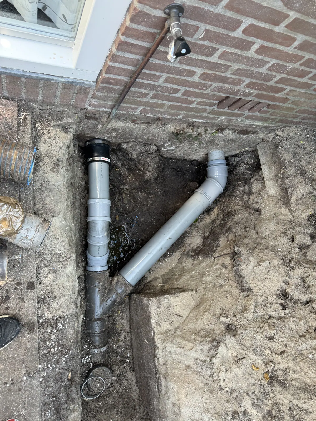 Dezelfde rioolaansluiting na herstel met nieuwe PVC-delen